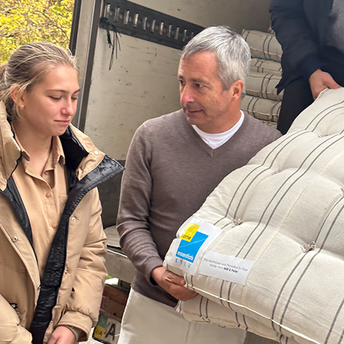 Crying girl receives mattress